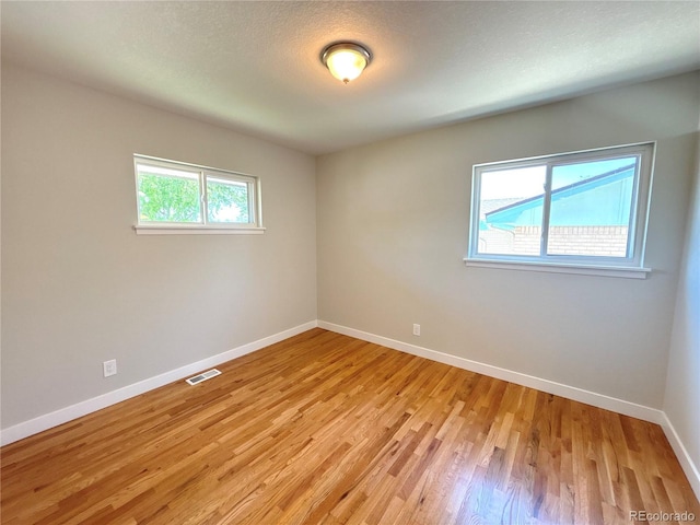 8239 Nola Dr, Denver, CO 80221 - spare room with baseboards and light wood finished floors