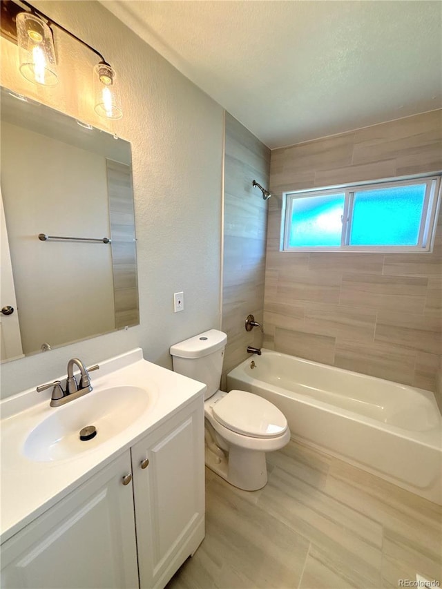 8239 Nola Dr, Denver, CO 80221 - bathroom with vanity, tub / shower combination, a textured wall, and a textured ceiling