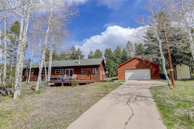 view of front of property with a deck, an outbuilding, and a garage