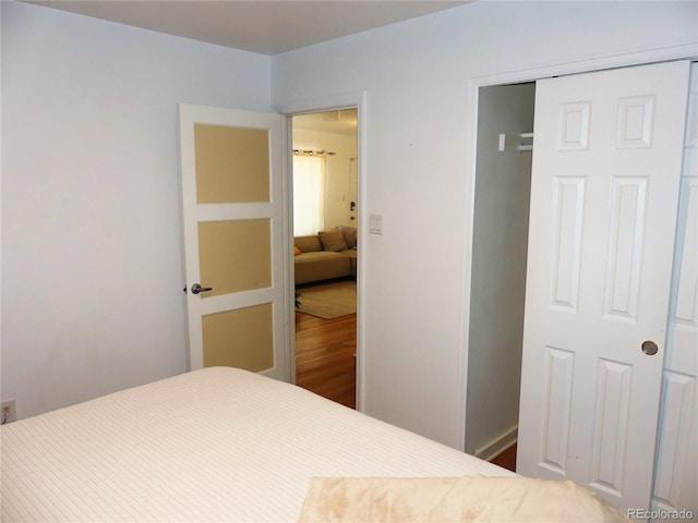 bedroom with hardwood / wood-style flooring and a closet