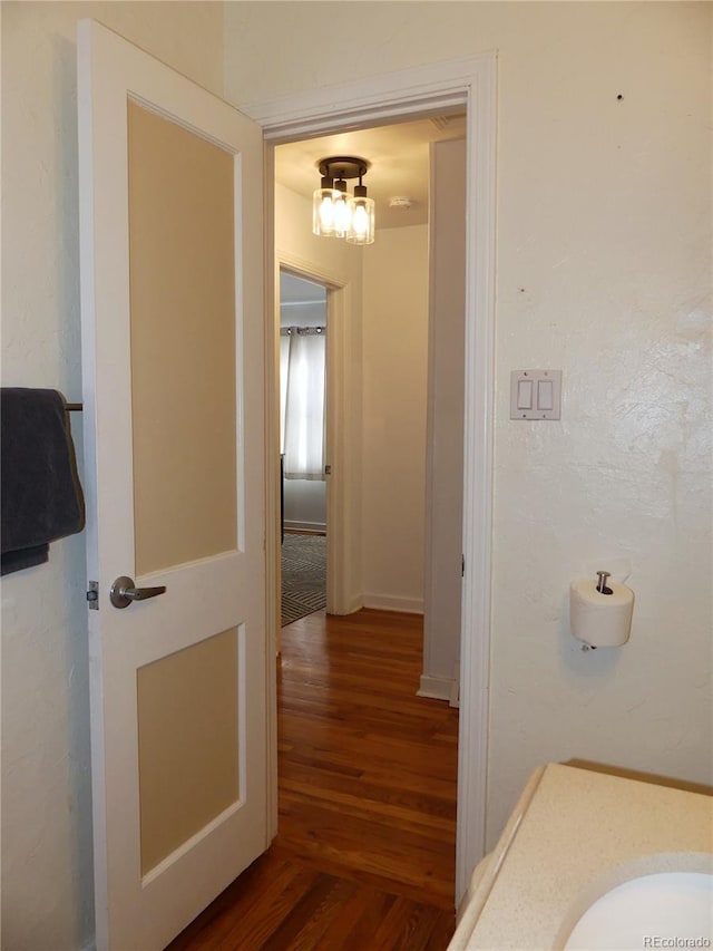 bathroom with hardwood / wood-style floors