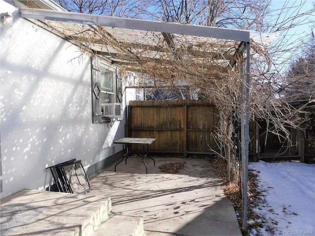 snow covered patio featuring cooling unit