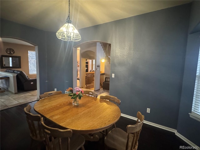 dining area with an inviting chandelier and hardwood / wood-style flooring