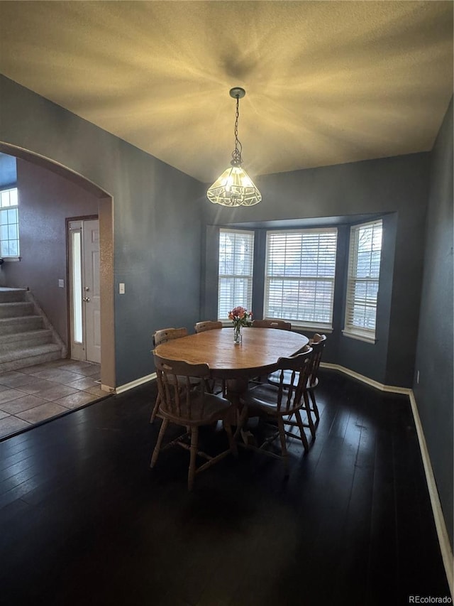 dining area featuring dark hardwood / wood-style flooring and a chandelier