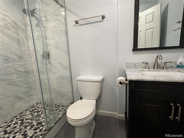 bathroom with toilet, vanity, an enclosed shower, and tile patterned floors