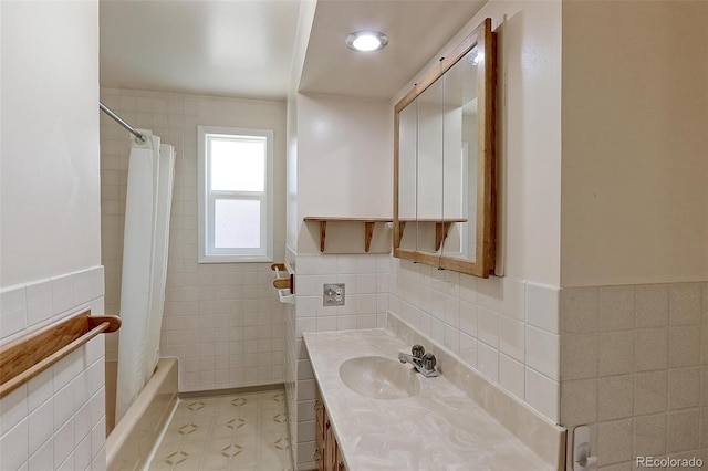 bathroom featuring vanity, tile walls, and shower / tub combo with curtain