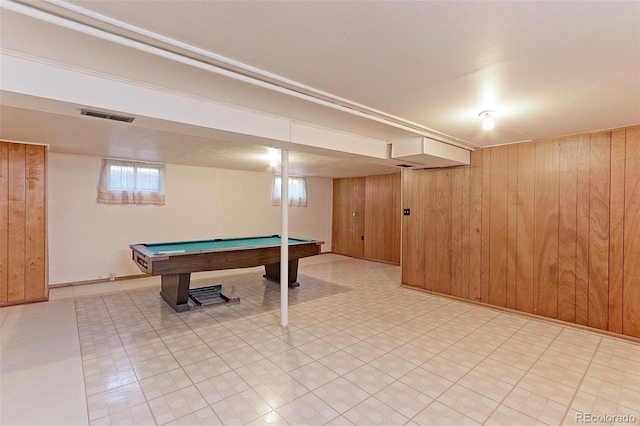 game room with wood walls and pool table