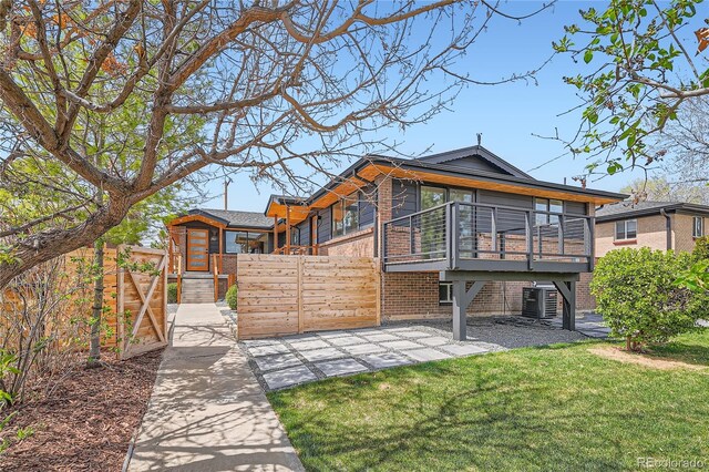 2065 Depew St, Edgewater, CO 80214 - back of house with stairs, brick siding, central air condition unit, a wooden deck, and a gate