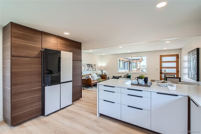 2065 Depew St, Edgewater, CO 80214 - kitchen with freestanding refrigerator, modern cabinets, light wood-style flooring, light countertops, and recessed lighting