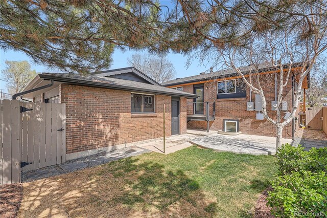 2065 Depew St, Edgewater, CO 80214 - back of property with brick siding, a gate, and a patio