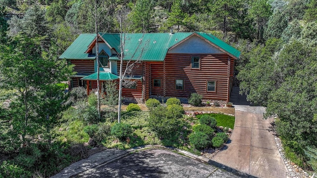 log-style house with log siding and metal roof