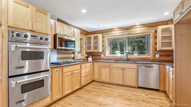 kitchen with light brown cabinetry, recessed lighting, appliances with stainless steel finishes, and a sink