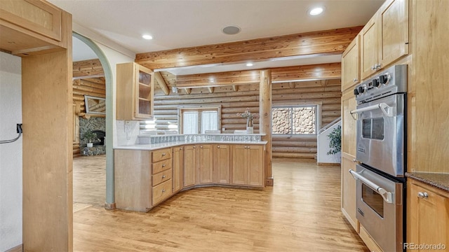 kitchen featuring recessed lighting, light wood-type flooring, beam ceiling, and double oven