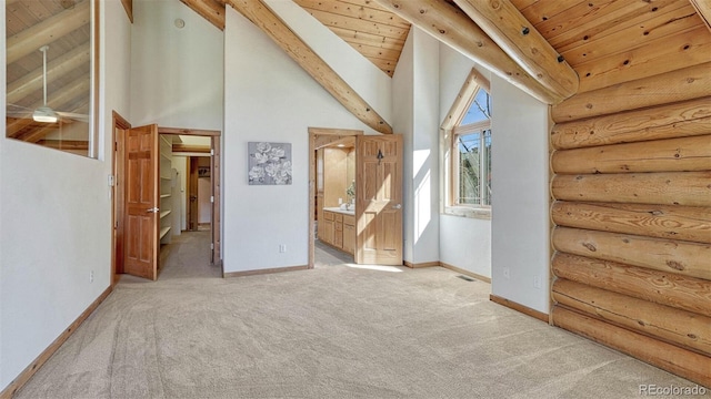 interior space featuring wood ceiling, baseboards, and high vaulted ceiling