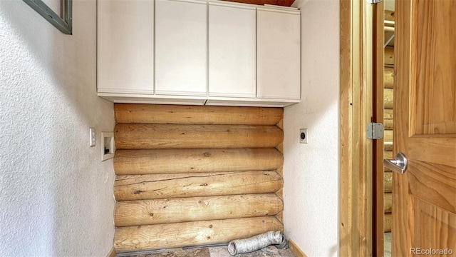 stairs featuring baseboards and a textured wall