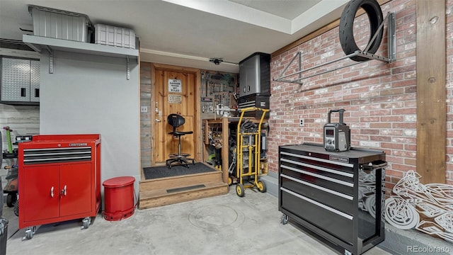 interior space featuring a workshop area and brick wall