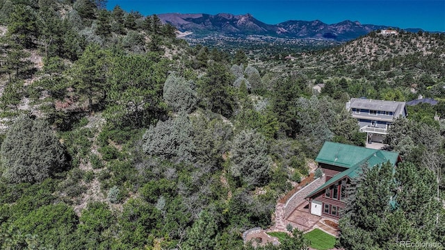 birds eye view of property with a view of trees and a mountain view