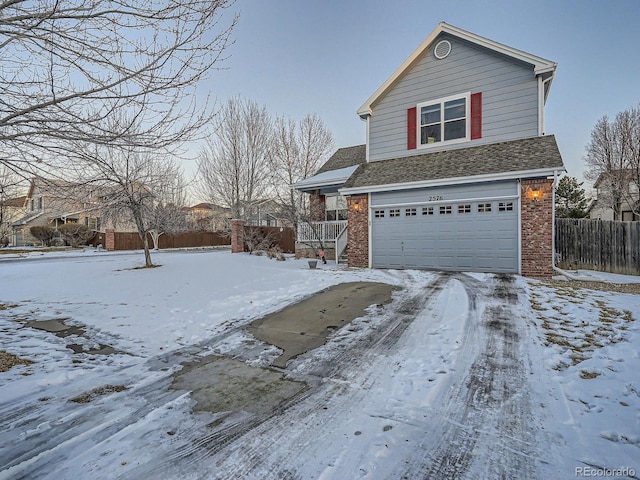 snow covered property featuring a garage