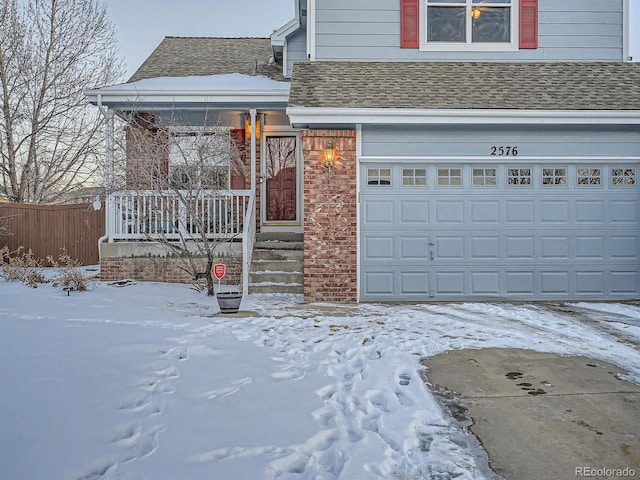 front of property featuring a garage and covered porch