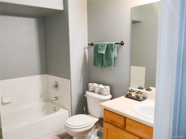 bathroom featuring a bath, toilet, and vanity