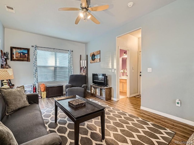 living room featuring light hardwood / wood-style flooring and ceiling fan