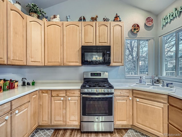 kitchen featuring sink, light brown cabinetry, and stainless steel range with gas stovetop