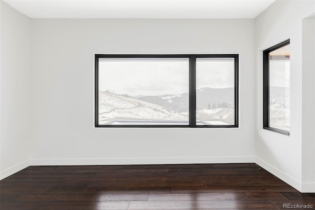 545 Strada Rossa Rd, Golden, CO 80401 - spare room with wood finished floors, baseboards, and a mountain view