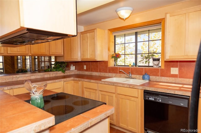 kitchen with light brown cabinets, exhaust hood, backsplash, black appliances, and sink