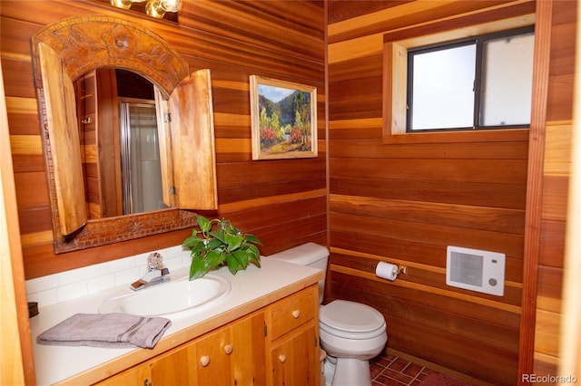 bathroom with vanity, wooden walls, and toilet