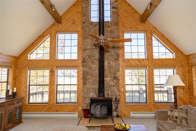 carpeted living room featuring baseboard heating, high vaulted ceiling, and plenty of natural light