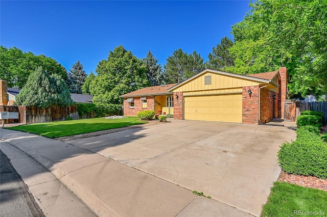 12348 Elizabeth Ct, Thornton, CO 80241 - ranch-style house with a garage, brick siding, driveway, and a chimney