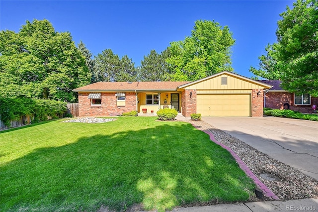 12348 Elizabeth Ct, Thornton, CO 80241 - ranch-style house featuring a garage, a front yard, brick siding, and driveway