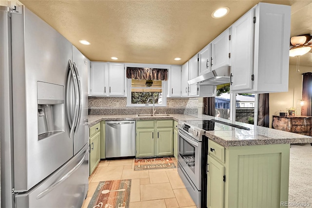 12348 Elizabeth Ct, Thornton, CO 80241 - kitchen with appliances with stainless steel finishes, under cabinet range hood, green cabinets, a sink, and decorative backsplash