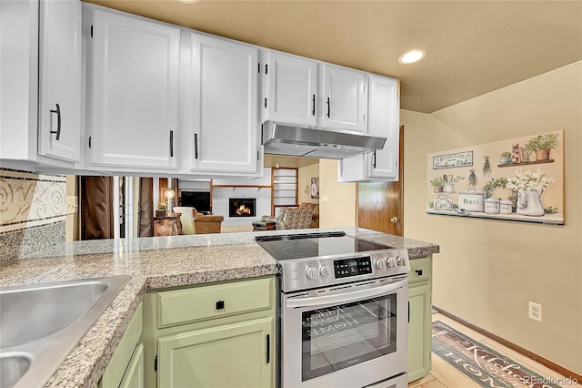 12348 Elizabeth Ct, Thornton, CO 80241 - kitchen with stainless steel electric range, under cabinet range hood, light countertops, and recessed lighting