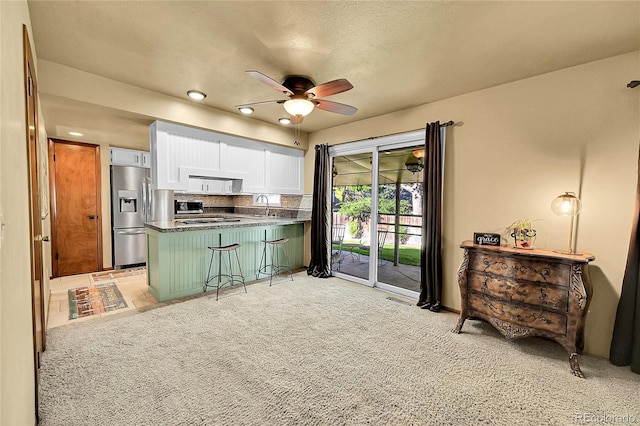 12348 Elizabeth Ct, Thornton, CO 80241 - kitchen featuring appliances with stainless steel finishes, a peninsula, white cabinetry, a ceiling fan, and a sink