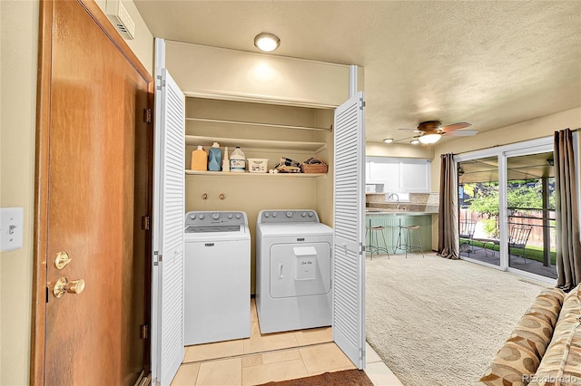 12348 Elizabeth Ct, Thornton, CO 80241 - washroom featuring independent washer and dryer, a ceiling fan, light tile patterned floors, a textured ceiling, and light colored carpet