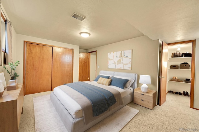12348 Elizabeth Ct, Thornton, CO 80241 - bedroom with light colored carpet, a closet, and a textured ceiling
