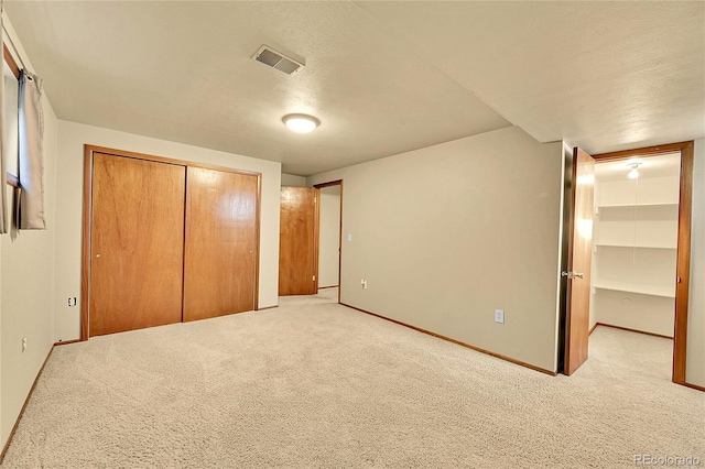 12348 Elizabeth Ct, Thornton, CO 80241 - unfurnished bedroom with a closet, light colored carpet, baseboards, and a textured ceiling