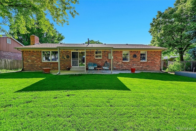 12348 Elizabeth Ct, Thornton, CO 80241 - rear view of property featuring a patio area, a chimney, and brick siding