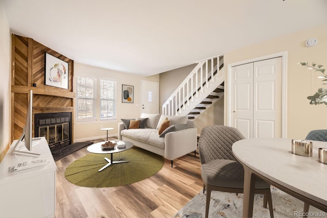 living room featuring hardwood / wood-style floors and a large fireplace