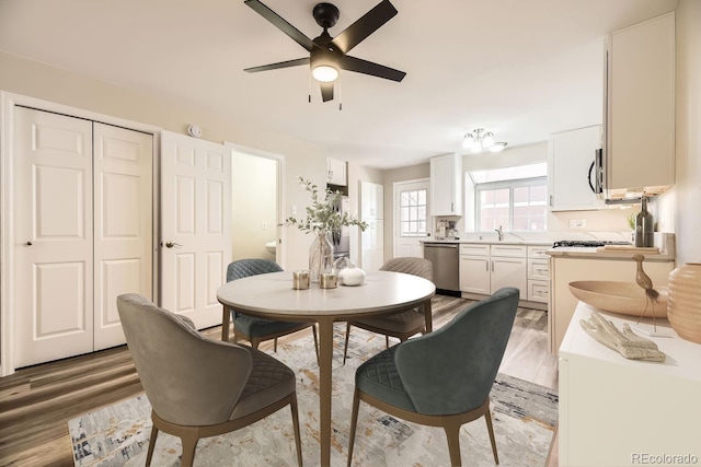 dining space featuring ceiling fan and hardwood / wood-style flooring