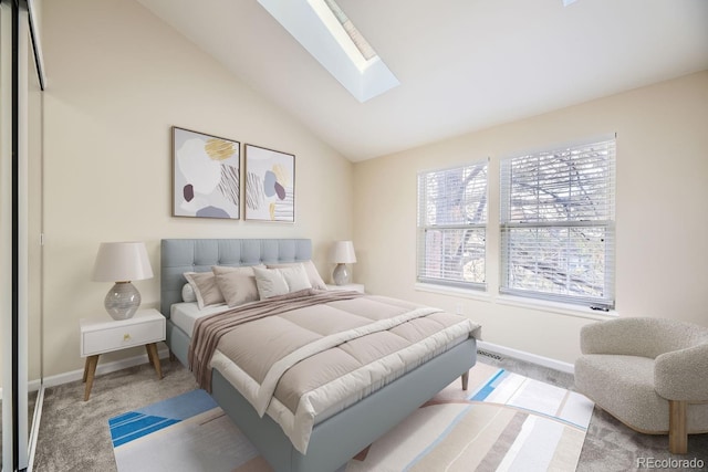 carpeted bedroom with vaulted ceiling with skylight