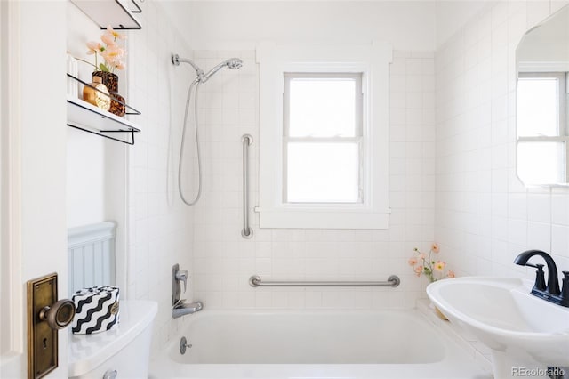 full bathroom with toilet, tiled shower / bath combo, and sink