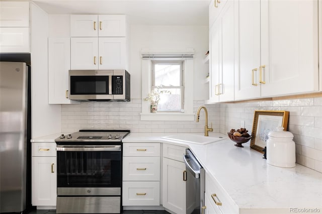 kitchen featuring white cabinets, sink, and stainless steel appliances