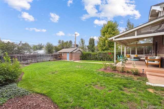 view of yard featuring ceiling fan, a storage shed, an outdoor hangout area, and a patio