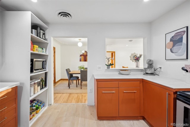 kitchen featuring stainless steel appliances and light hardwood / wood-style floors