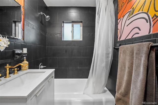 bathroom with vanity, tile walls, and shower / tub combo with curtain