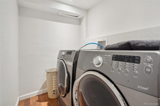 washroom featuring hardwood / wood-style flooring and independent washer and dryer