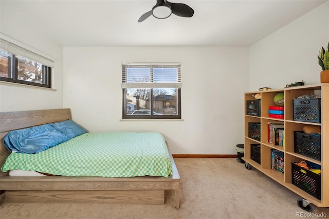 bedroom with baseboards, carpet, and a ceiling fan
