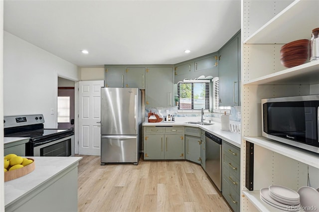 2042 Jamaica St, Aurora, CO 80010 - kitchen featuring stainless steel appliances, a sink, light wood-type flooring, green cabinets, and recessed lighting